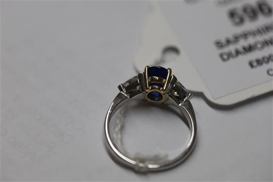 A modern 18ct white gold sapphire and diamond three stone dress ring, size M.